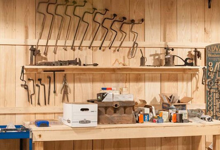 The garage walls are lined with vintage tools